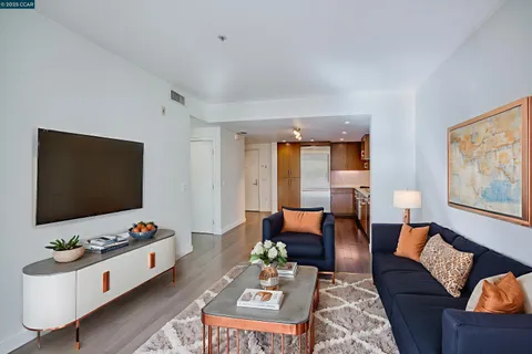 a bedroom with a bed a couch and a potted plant