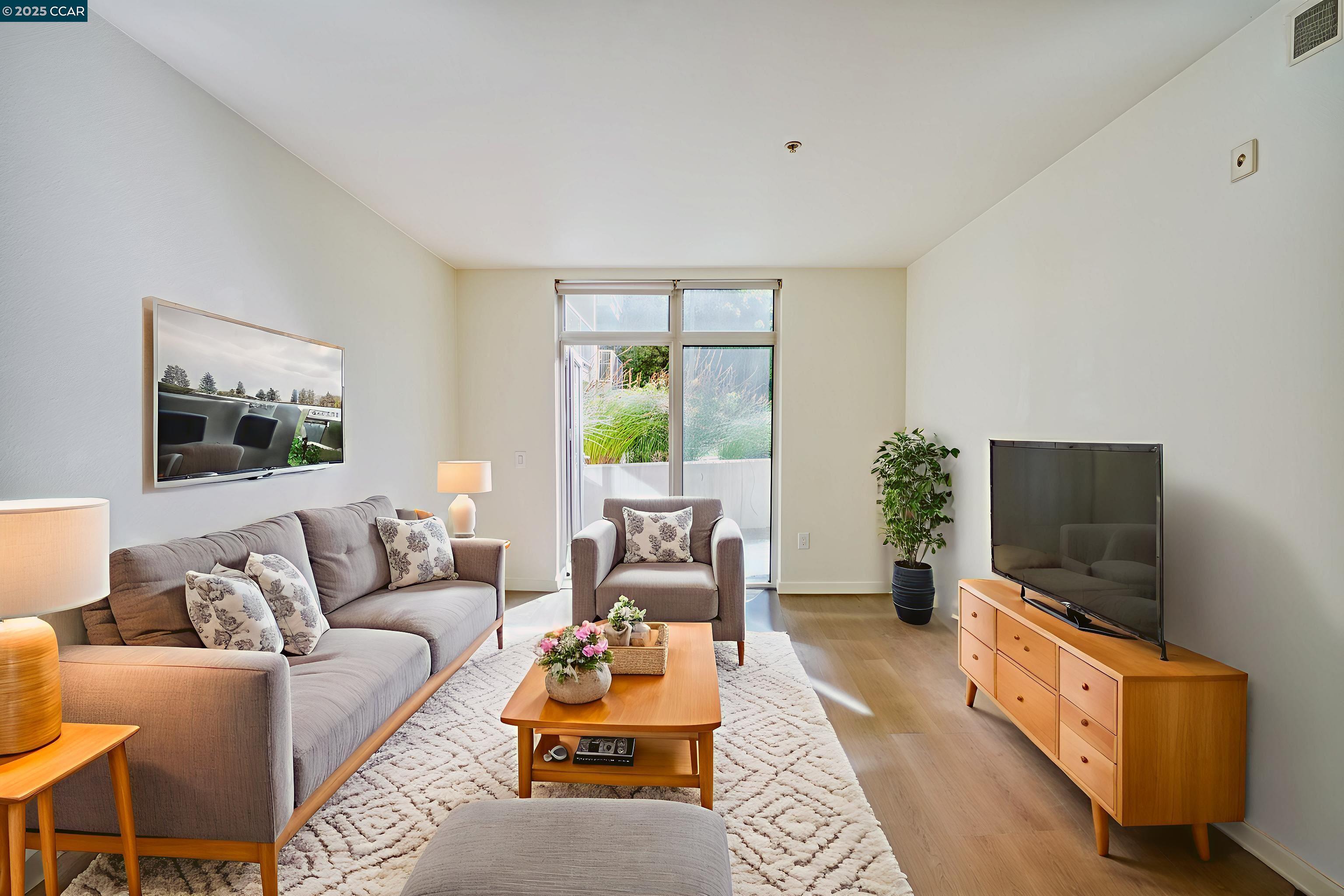 2655 Bush Street, Unit 110 San Francisco, CA 94115 - Photo 12 of 52 a living room with furniture a flat screen tv and a large window