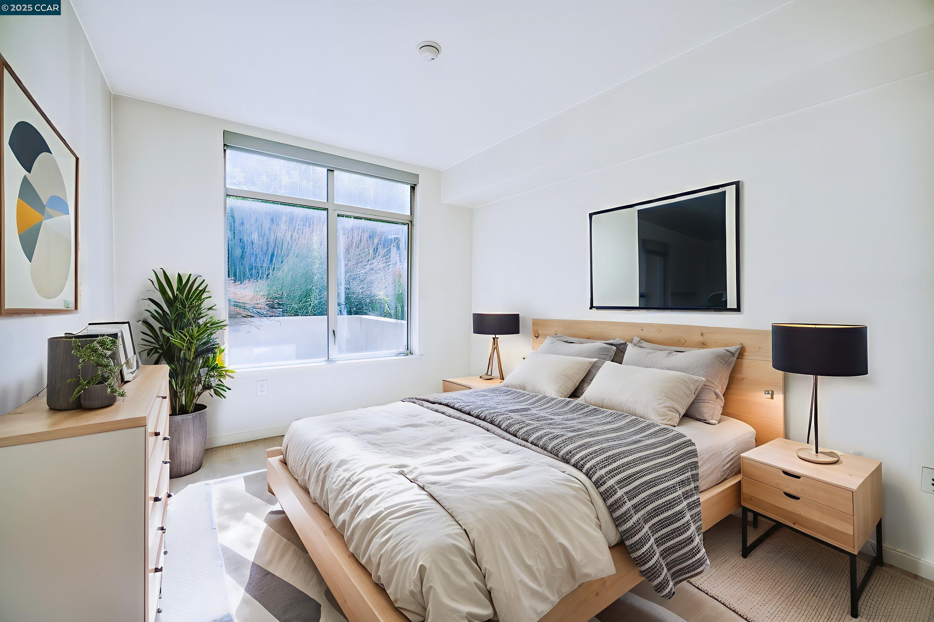 2655 Bush Street, Unit 110 San Francisco, CA 94115 - Photo 14 of 52 a bedroom with a bed and a potted plant