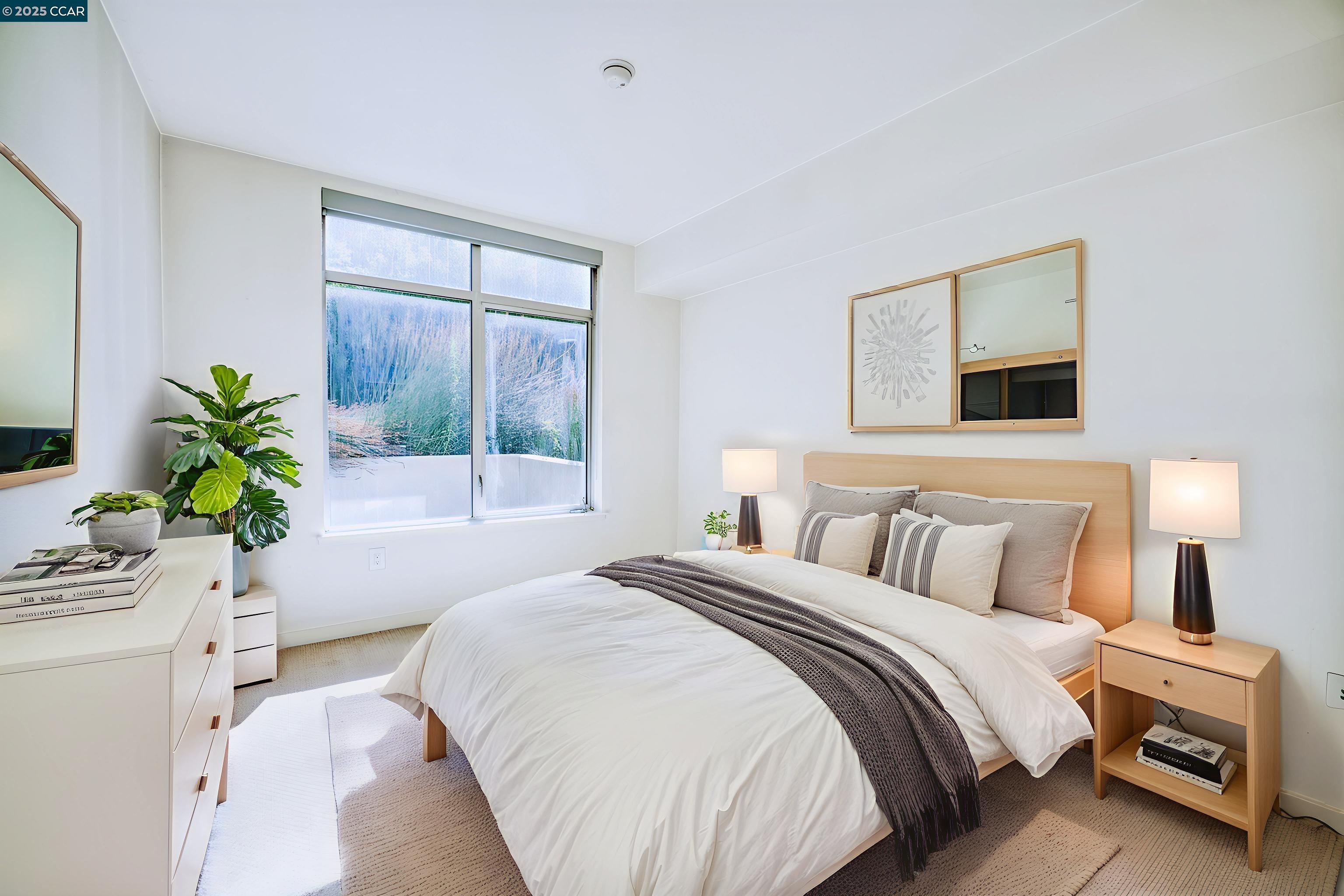 2655 Bush Street, Unit 110 San Francisco, CA 94115 - Photo 15 of 52 a bedroom with a bed windows and a potted plant
