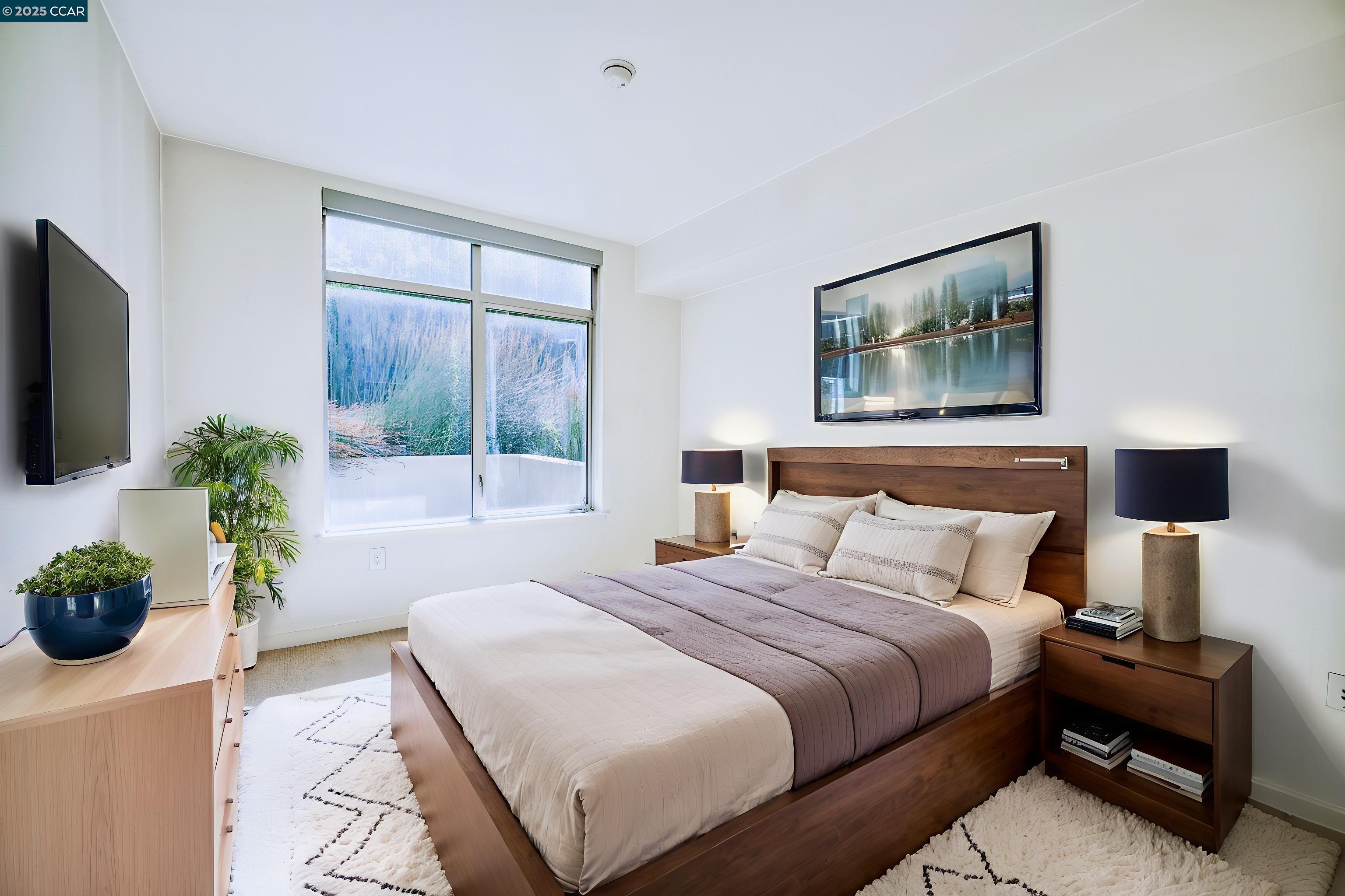 2655 Bush Street, Unit 110 San Francisco, CA 94115 - Photo 17 of 52 a bedroom with a bed a couch and a potted plant