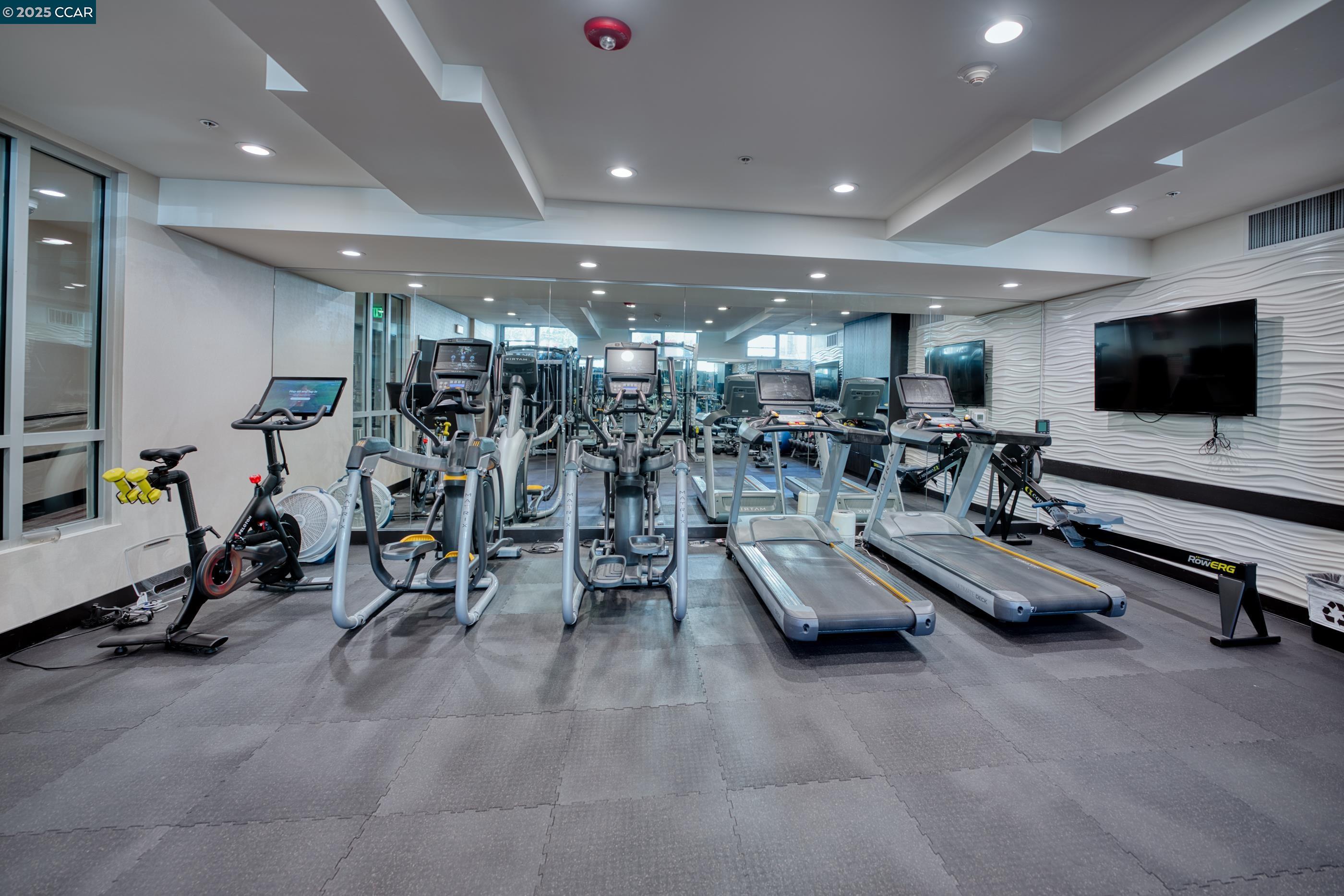 2655 Bush Street, Unit 110 San Francisco, CA 94115 - Photo 39 of 52 a view of a room with gym equipment and a large mirror