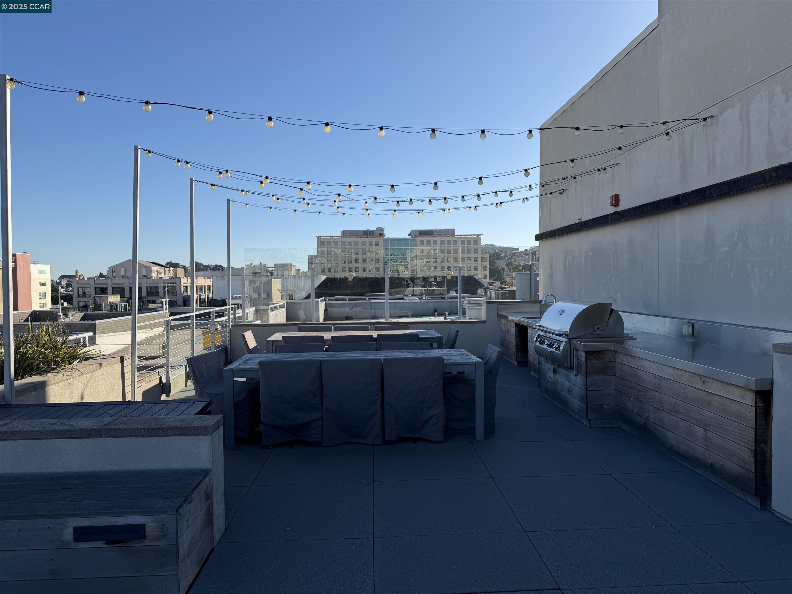 2655 Bush Street, Unit 110 San Francisco, CA 94115 - Photo 44 of 52 a room with stainless steel appliances kitchen island granite countertop a stove a sink and a refrigerator
