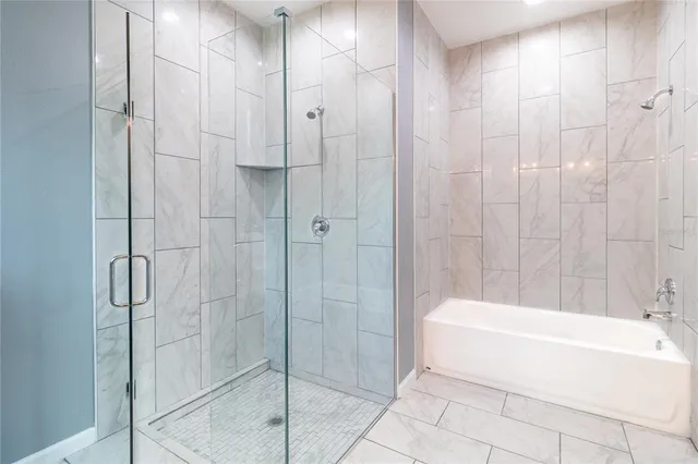 a bathroom with a bathtub and shower
