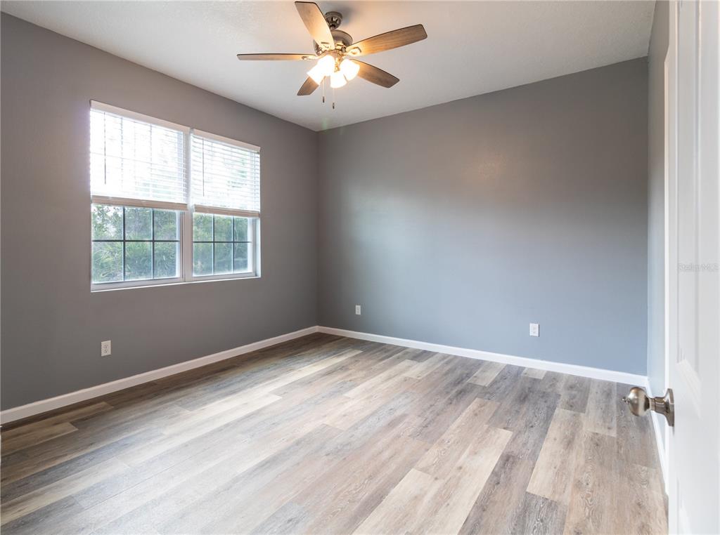 41550 Royal Trails Road Eustis, FL 32736 - Photo 14 of 25 wooden floor in an empty room with a window