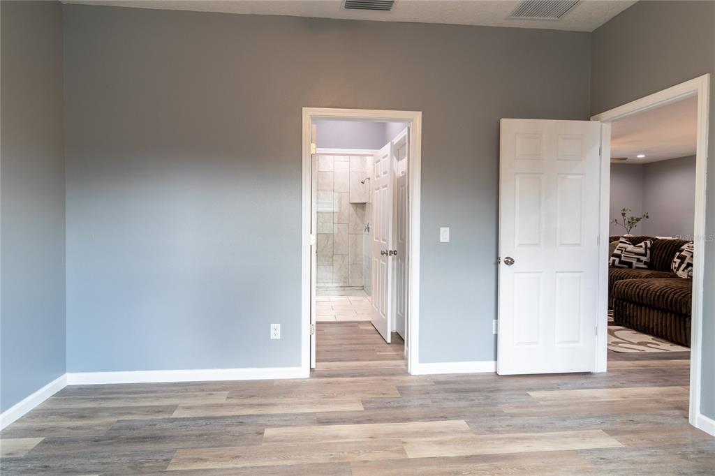 41550 Royal Trails Road Eustis, FL 32736 - Photo 15 of 25 a view of a hallway with wooden floor and a bathroom