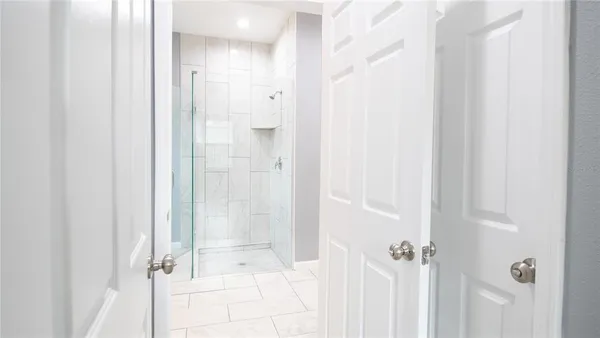 a bathroom with a glass shower door