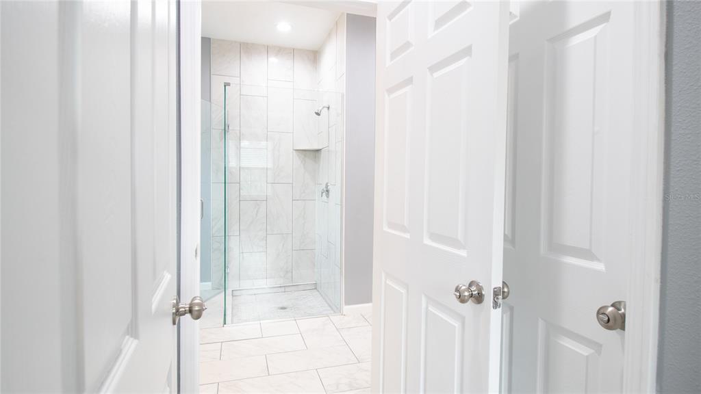 41550 Royal Trails Road Eustis, FL 32736 - Photo 16 of 25 a bathroom with a glass shower door