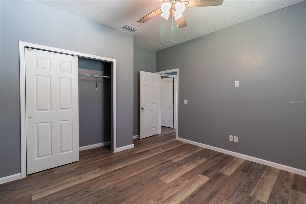 41550 Royal Trails Road Eustis, FL 32736 - Photo 20 of 25 an empty room with wooden floor closet and windows