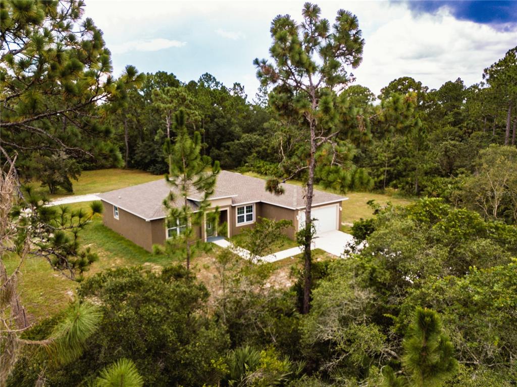 41550 Royal Trails Road Eustis, FL 32736 - Photo 25 of 25 a view of a house with a yard and lake