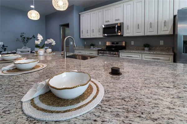a kitchen with a sink a stove and cabinets