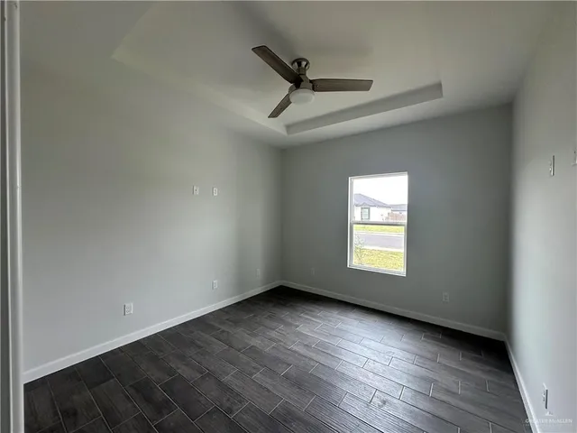 a view of room window and a ceiling fan