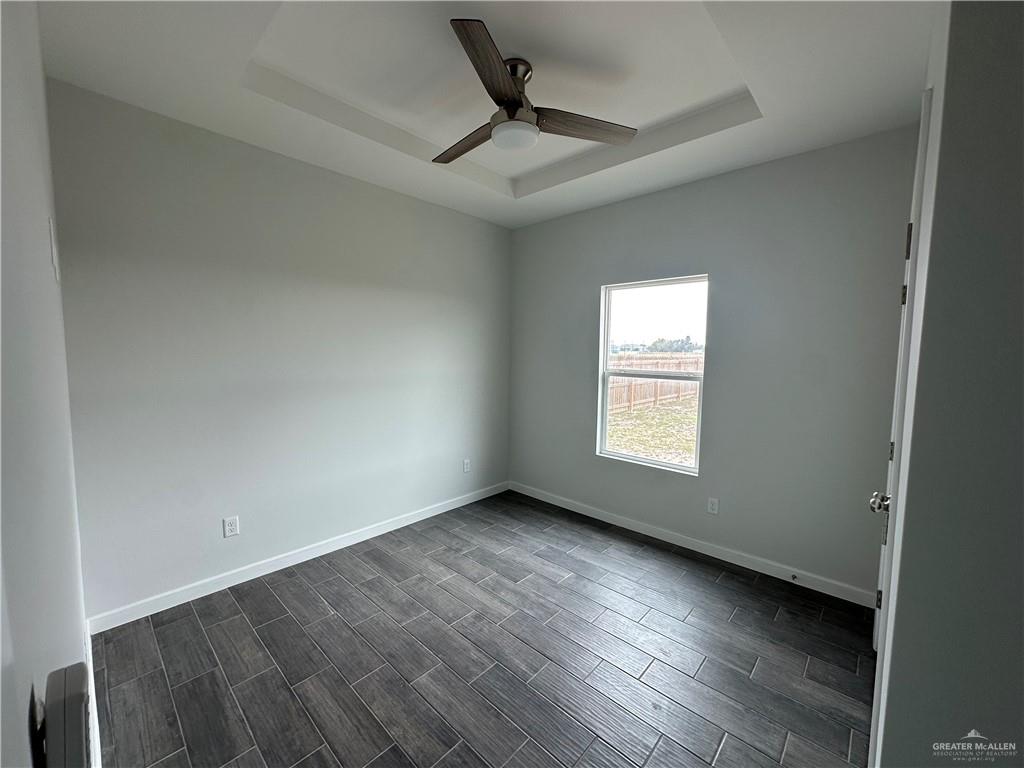 1708 Unity Drive Mercedes, TX 78570 - Photo 10 of 11 an empty room with wooden floor and windows