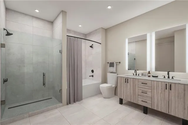 a bathroom with a double vanity sink toilet and shower
