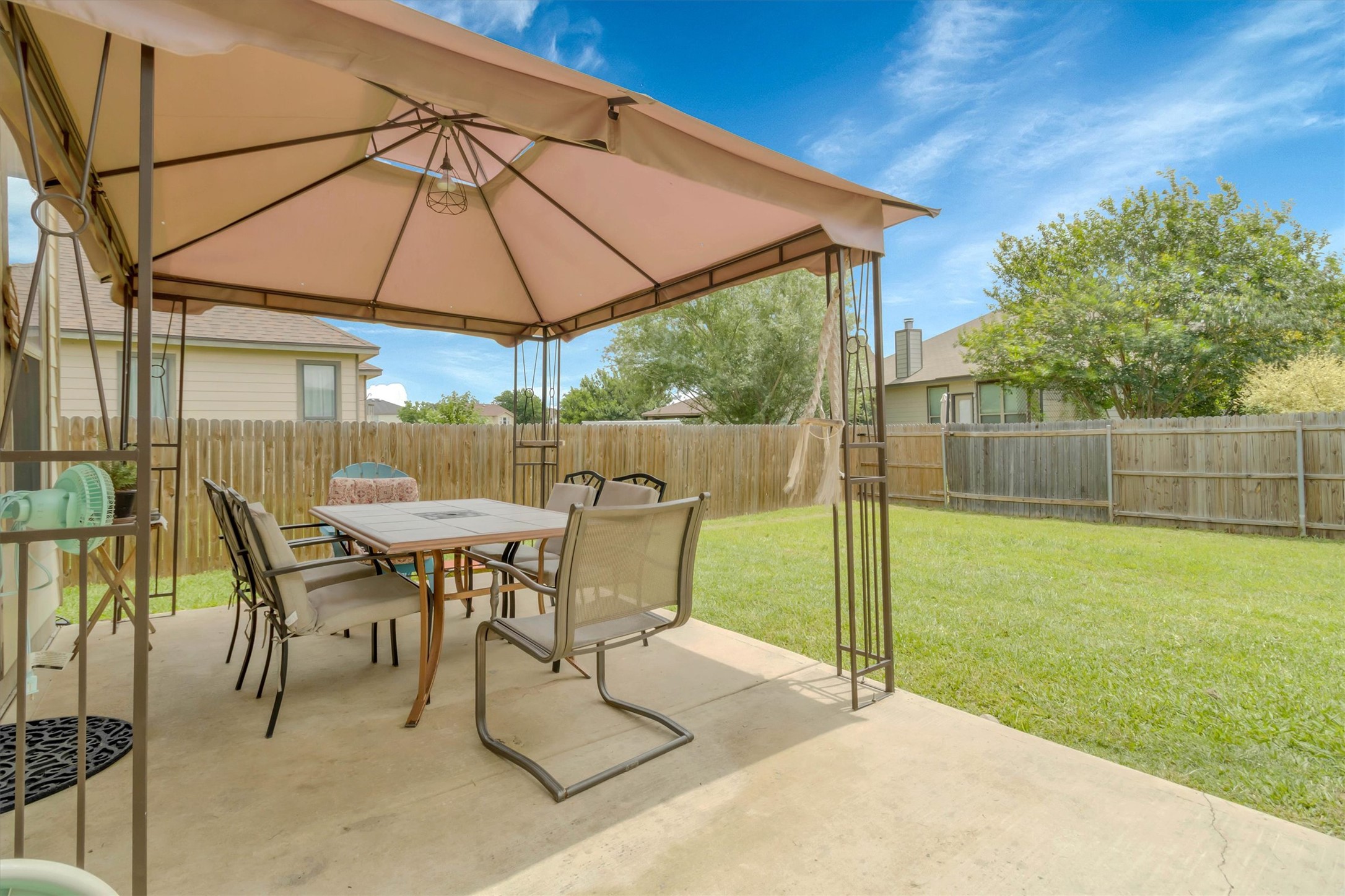 460 Waterleaf Boulevard Kyle, TX 78640 - Photo 24 of 30 A spacious backyard with a covered patio offers ample room for outdoor activities.