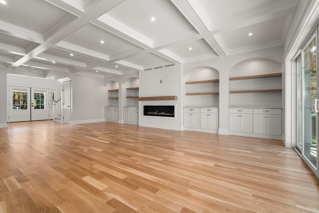 21 Quiet Street Sandwich, MA 02537 - Photo 4 of 15 an empty room with wooden floor fireplace and windows