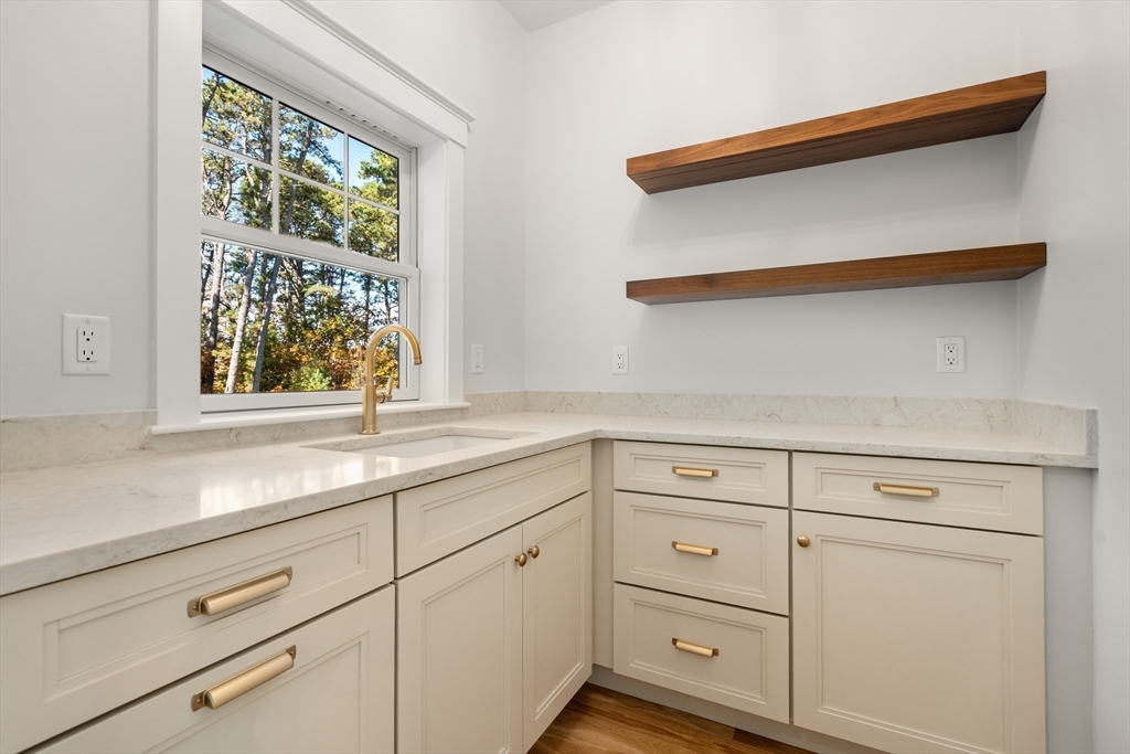 21 Quiet Street Sandwich, MA 02537 - Photo 8 of 15 a kitchen with white cabinets and a window