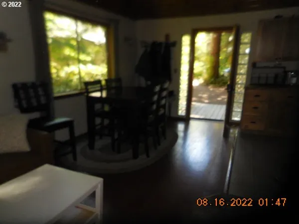 a view of a livingroom with furniture and an empty room