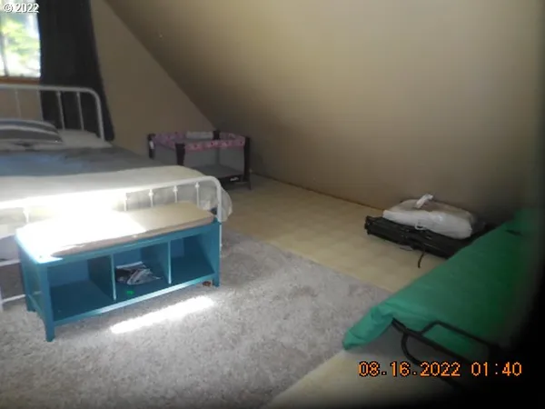 a bed sitting in a bedroom next to a window