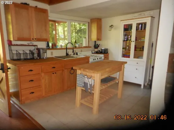 a kitchen with a stove a sink and a cabinets