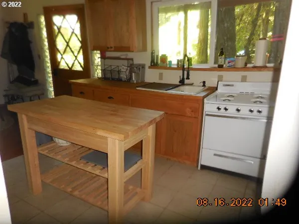 a kitchen that has a sink and a stove in it