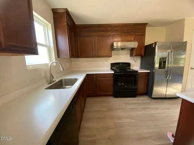 a kitchen with a sink and cabinets