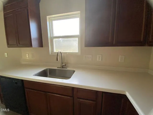 a bathroom with a sink a toilet and a large mirror