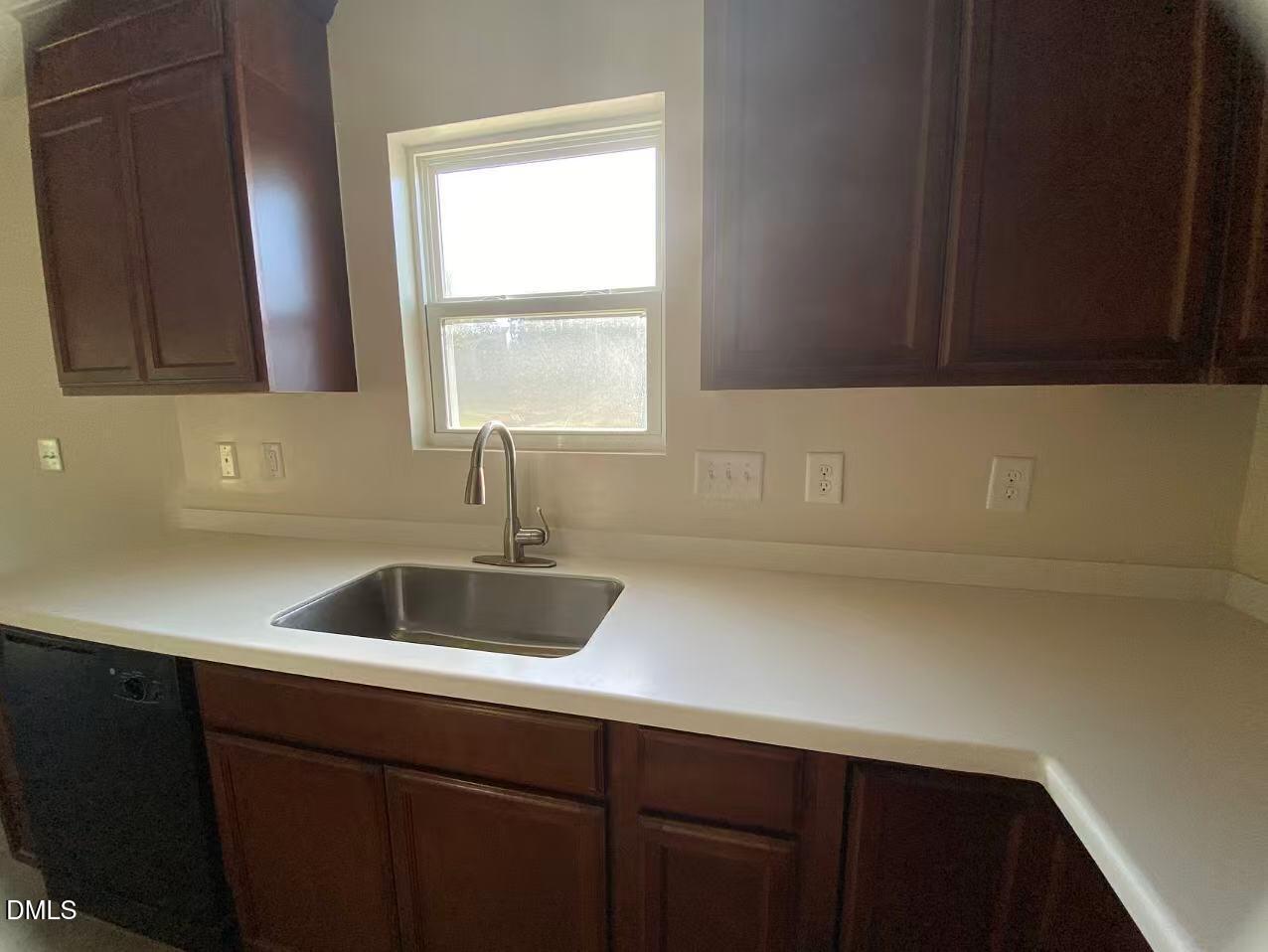 27 Ridgemoore Court Four Oaks, NC 27524 - Photo 21 of 24 a kitchen with a sink and cabinets