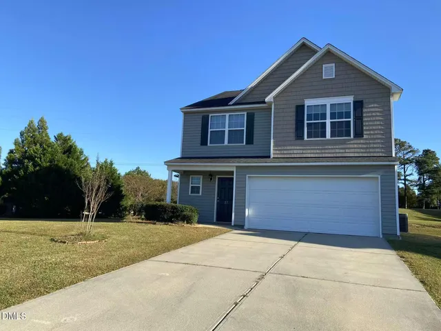 a front view of a house with a yard