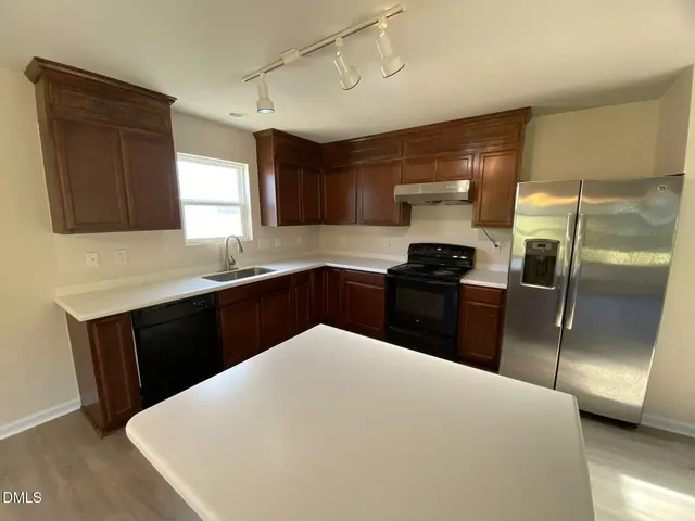a kitchen with a refrigerator and a sink