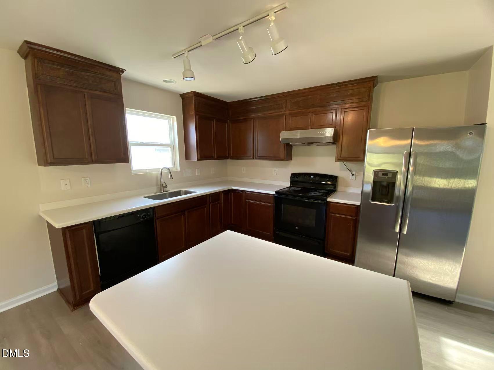 27 Ridgemoore Court Four Oaks, NC 27524 - Photo 4 of 24 a kitchen with a refrigerator and a sink