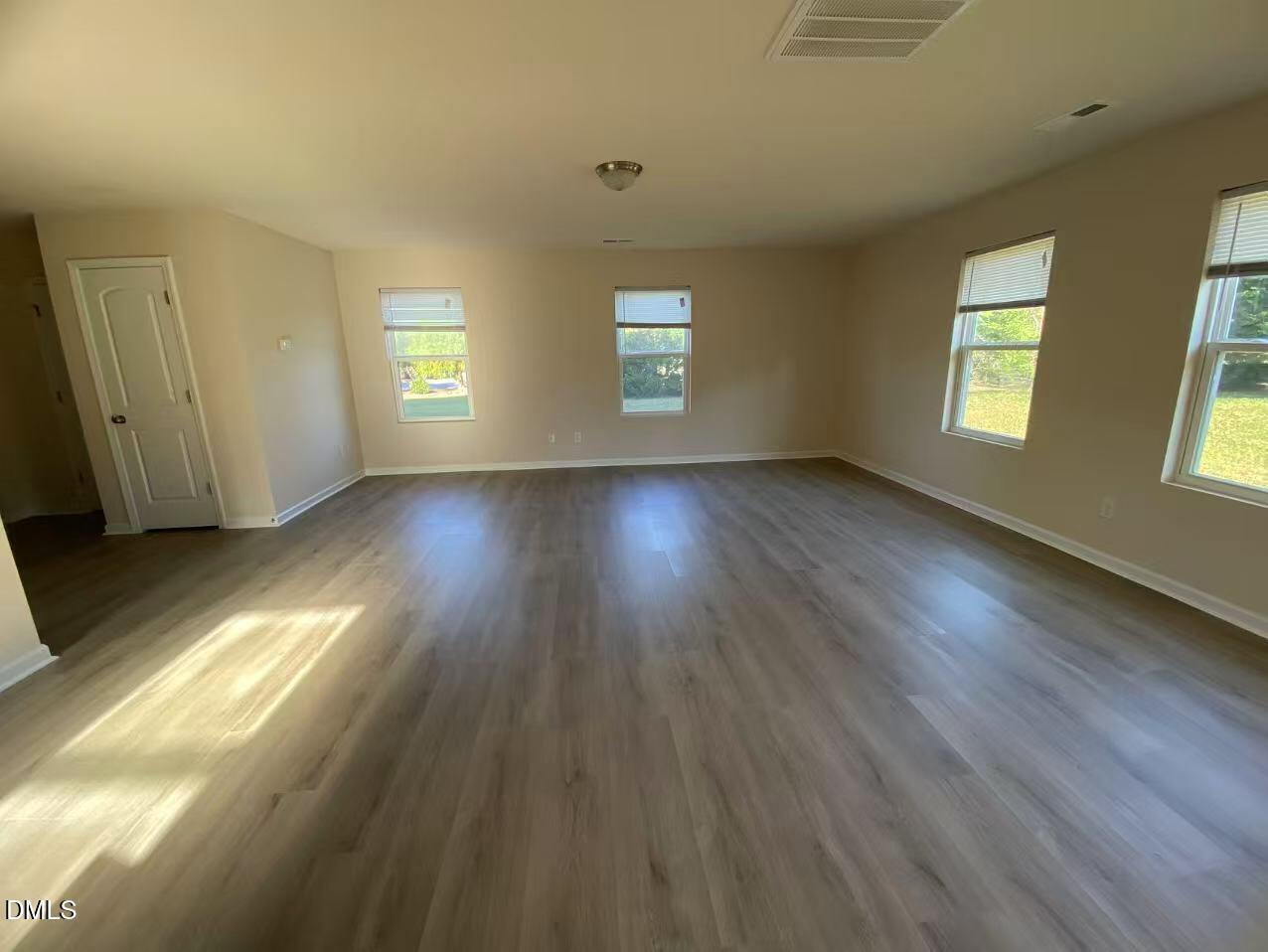 27 Ridgemoore Court Four Oaks, NC 27524 - Photo 7 of 24 a view of an empty room with wooden floor and window