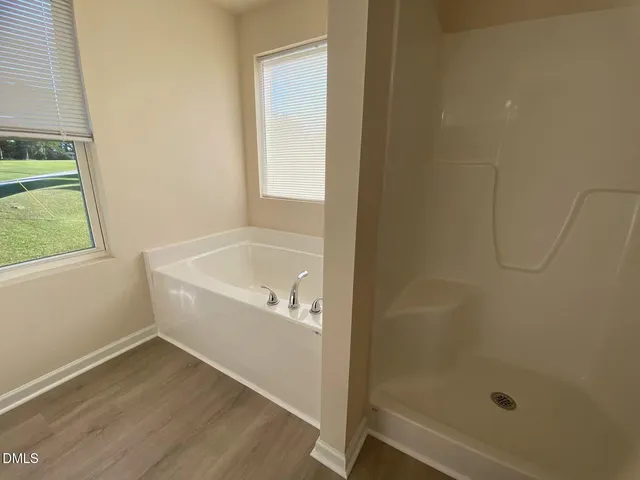 a white bath tub sitting next to a window