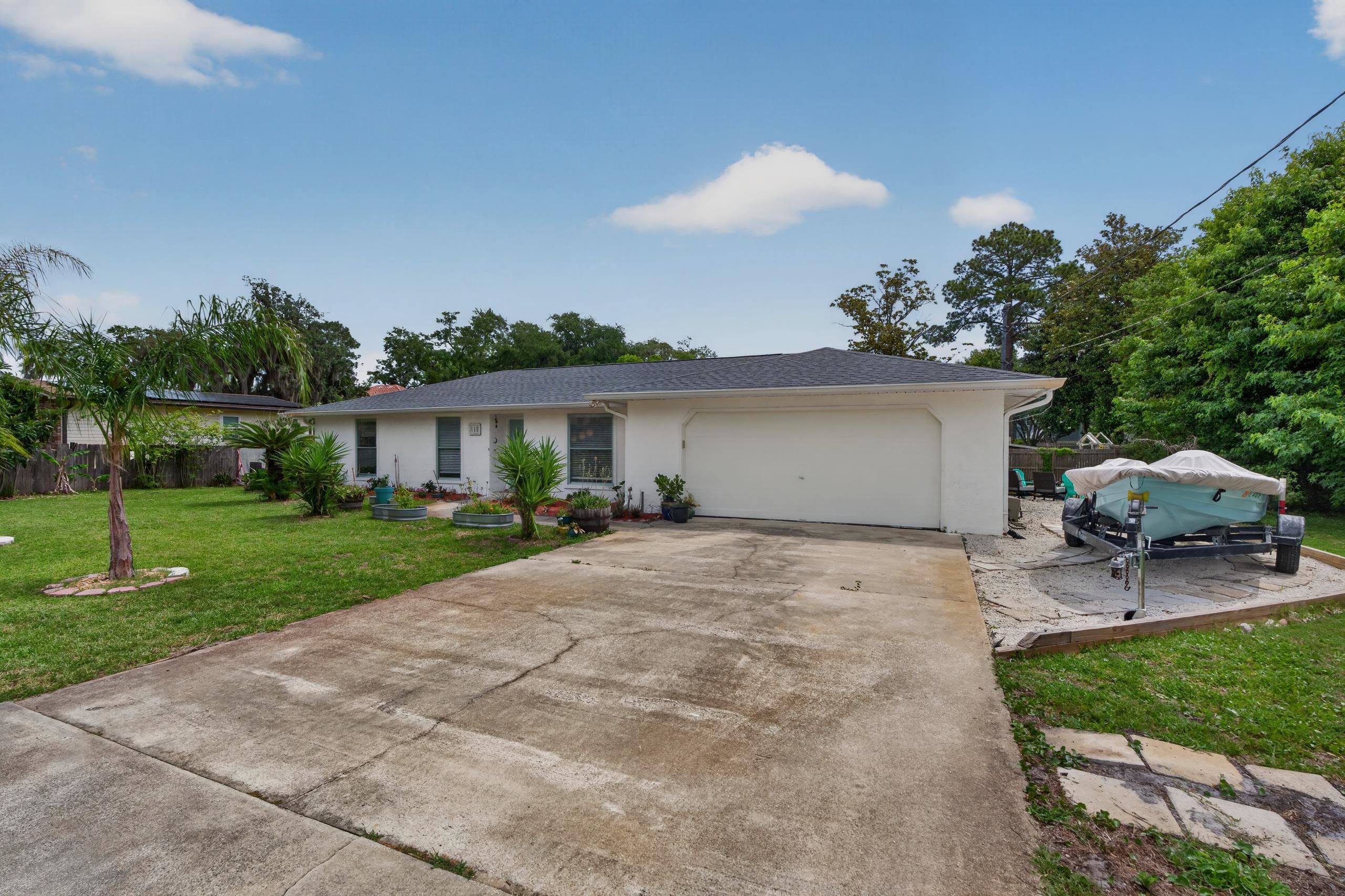 111 Pompano Road St. Augustine, FL 32086 - Photo 45 of 61 a view of a patio with a table and chairs under an umbrella