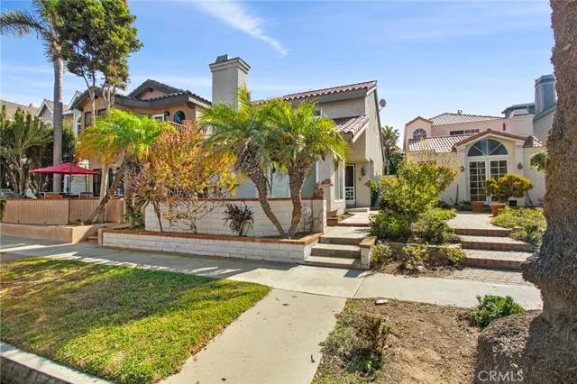 a front view of a house with plants
