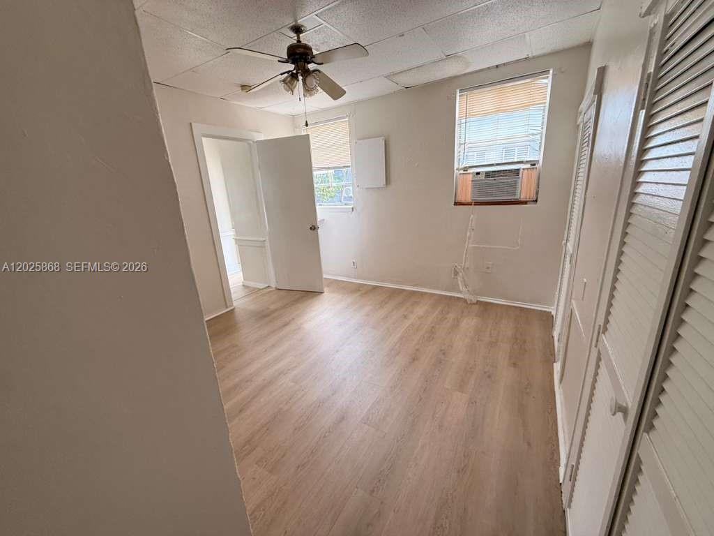 1919 Southwest 2nd Street, Unit B Miami, FL 33135 - Photo 11 of 12 wooden floor in an empty room with a window