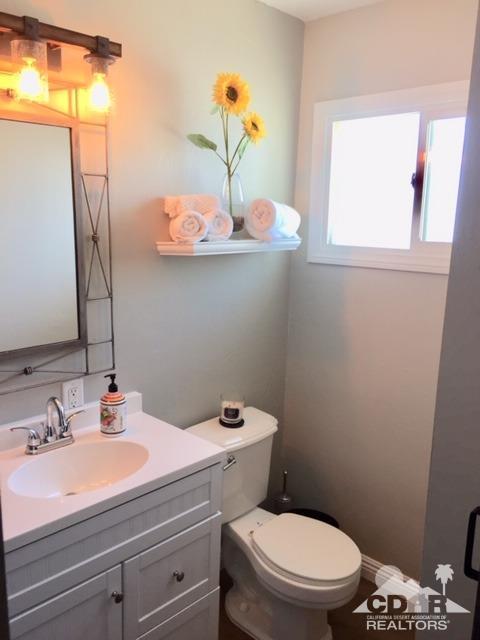 10394 Cochran Avenue Riverside, CA 92505 - Photo 2 of 12 a bathroom with a sink a toilet and mirror