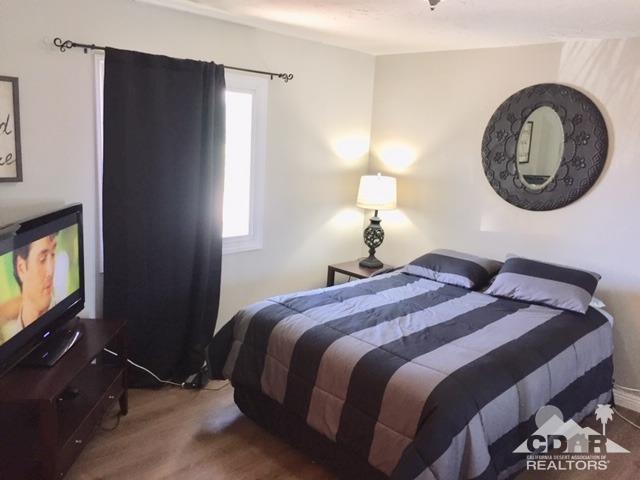 10394 Cochran Avenue Riverside, CA 92505 - Photo 4 of 12 a bedroom with a bed and a flat tv screen on the dresser
