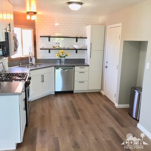10394 Cochran Avenue Riverside, CA 92505 - Photo 5 of 12 a kitchen with a sink stove and cabinets