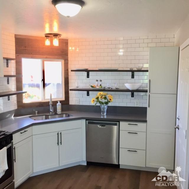 10394 Cochran Avenue Riverside, CA 92505 - Photo 6 of 12 a kitchen with a sink dishwasher and cabinets