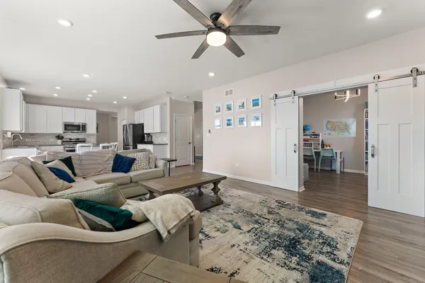 a living room with furniture and kitchen view