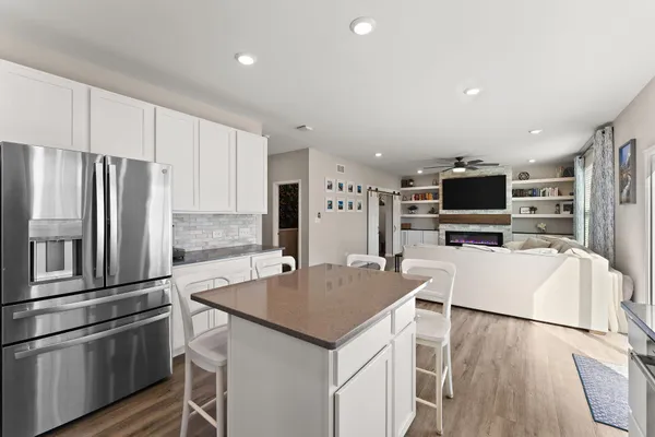 a kitchen with stainless steel appliances a refrigerator sink and microwave