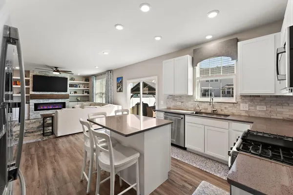 a kitchen with a sink stainless steel appliances and cabinets