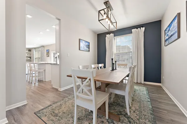 a view of a dining room with furniture window and wooden floor