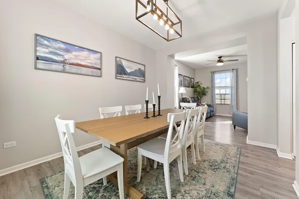 a dining room with furniture and wooden floor