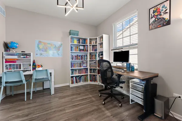 a view of a workspace with furniture and a window