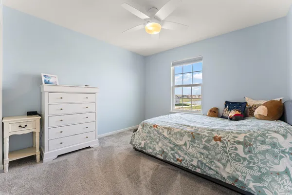a bedroom with a bed and with furniture