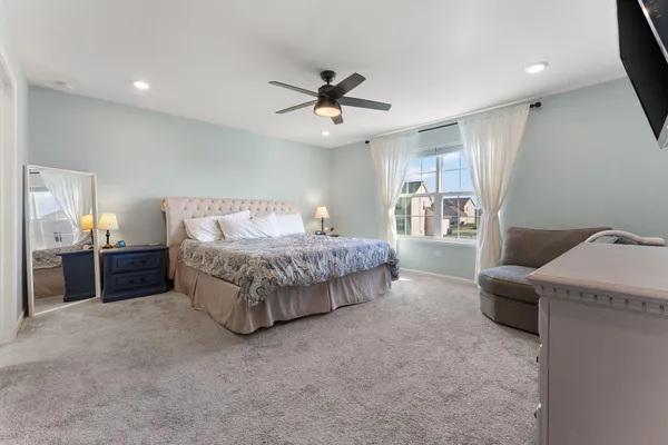 a bedroom with bed and window