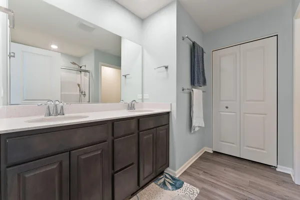 a bathroom with double vanity sinks and a mirror