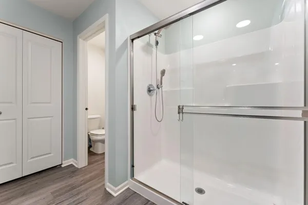 a bathroom with a shower and a glass door